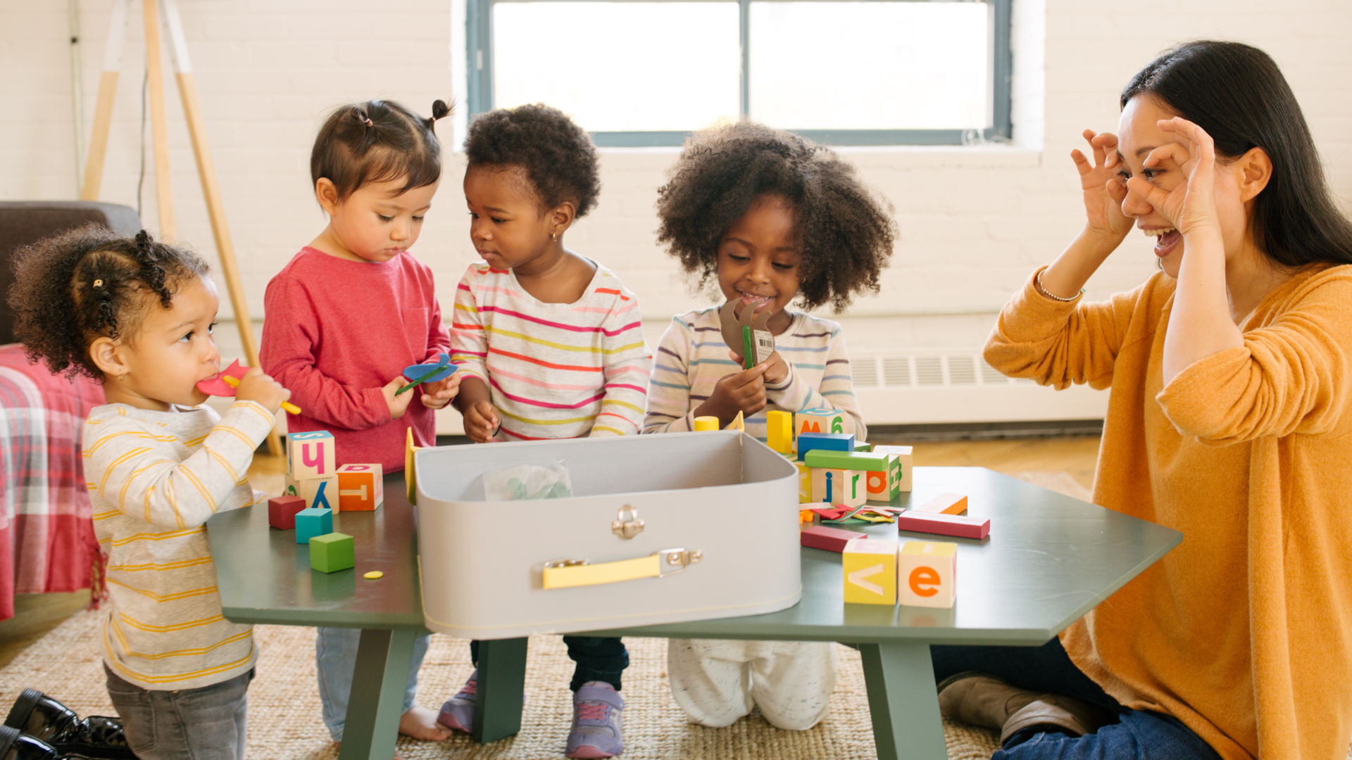Image of young toddlers playing at a table together with their teacher. "It all starts with you. Break the cycle. Invest in early childhood. Dive into the proof. Become your child's first teacher. Advocate."