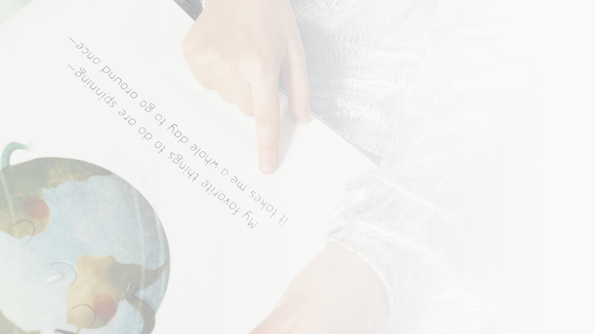 Image. ofa hand pointing to the words "My favorite things to do are spinning - " on a page with a globe.